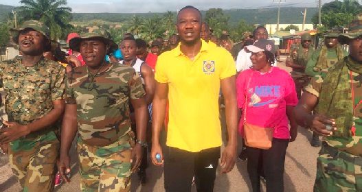 Christopher Apawu (middle) leading management and staff to climb the Asinesi Mountain to end the breast cancer awareness month. They were joined by some soldiers on the walk. Christopher Apawu (middle) leading management and staff to climb the Asinesi Mountain to end the breast cancer awareness month. They were joined by some soldiers on the walk.